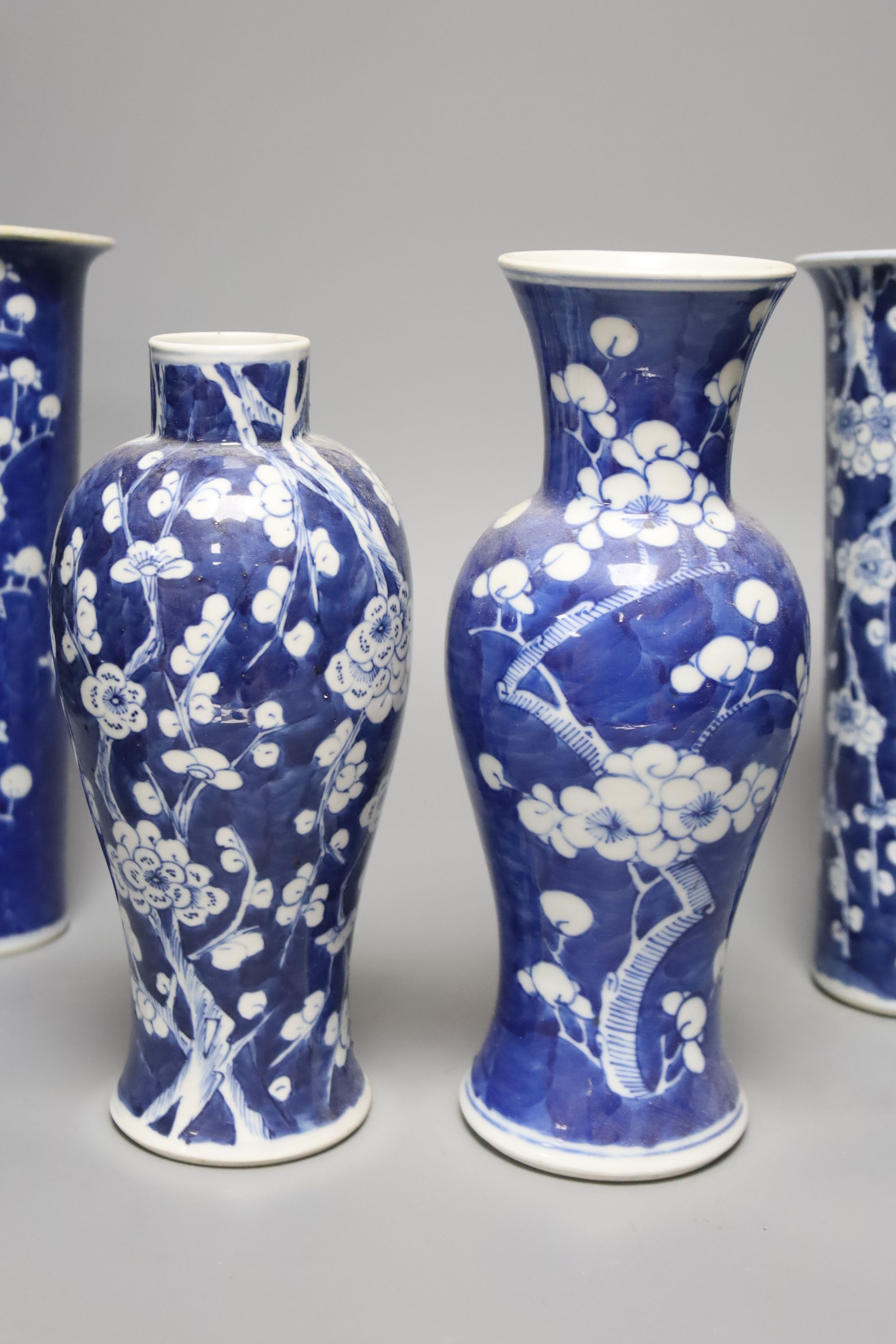 Four Chinese prunus pattern vases and a vase and cover, tallest 26.5cm